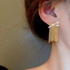 Close-up detail of the sparkling zircons and plating on the X Tassel Earrings