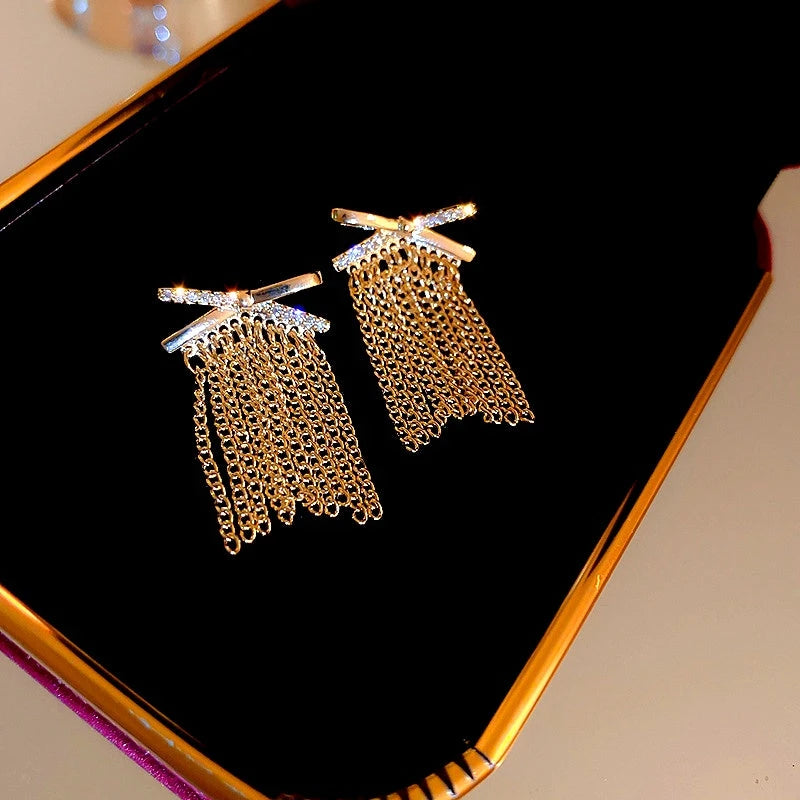 Angled view of the 14K Gold-Plated Elegant Zircon X Tassel Earrings