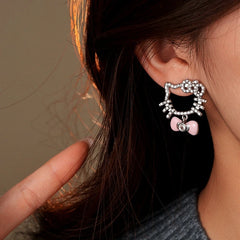 Model showcasing the dangle and style of the 14K Gold-Plated Elegant Zircon  Bow Kitten Earrings