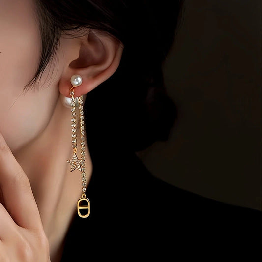 Model showcasing the dangle and style of the 14K Gold-Plated Elegant Zircon Zircon Star Pearl Earrings
