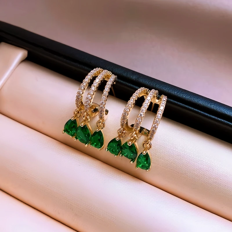 Angled view of the 14K Gold-Plated Elegant Green Zircon Diamond Tassel Earrings
