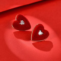 Model showcasing the dangle and style of the 14K Gold-Plated Elegant Zircon Wine Red Heart Stud Earrings