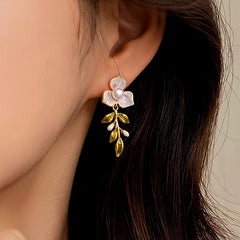 Model showcasing the dangle and style of the 18K Gold-Plated Enamel Oil-Drop Flower Pearl Earrings