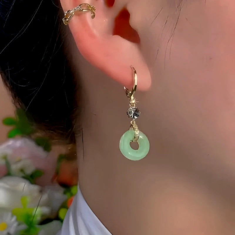 Close-up detail of the sparkling zircons and plating on the Peace Buckle Earrings