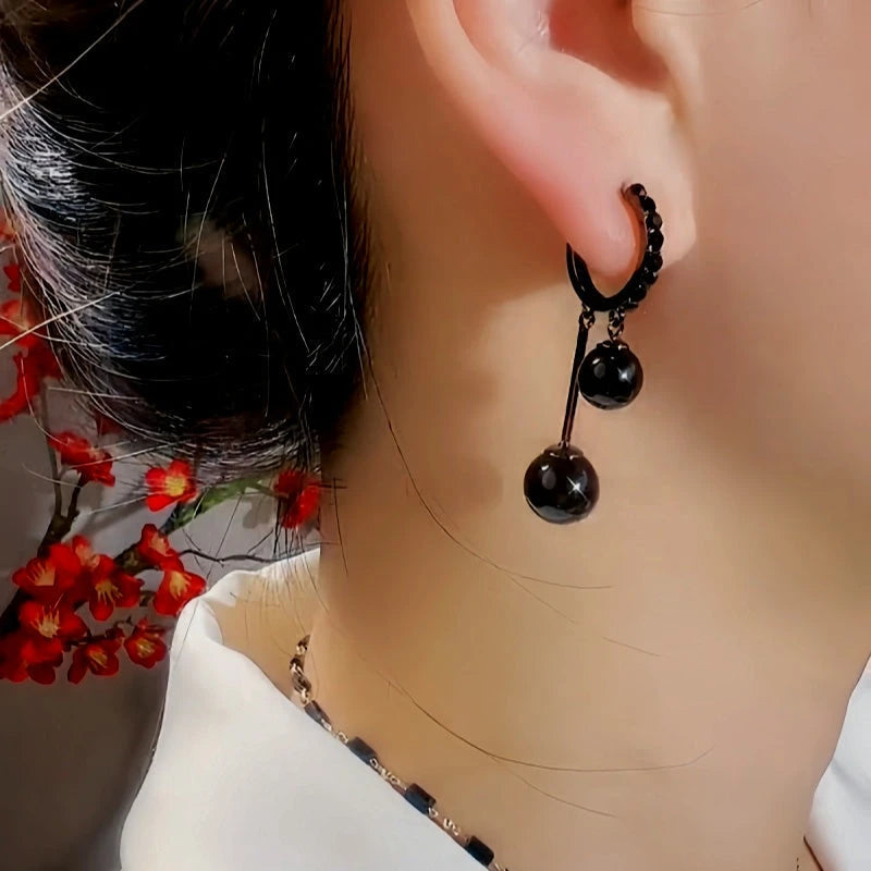 Close-up detail of the sparkling zircons and plating on the Black Ball Pearl Earrings