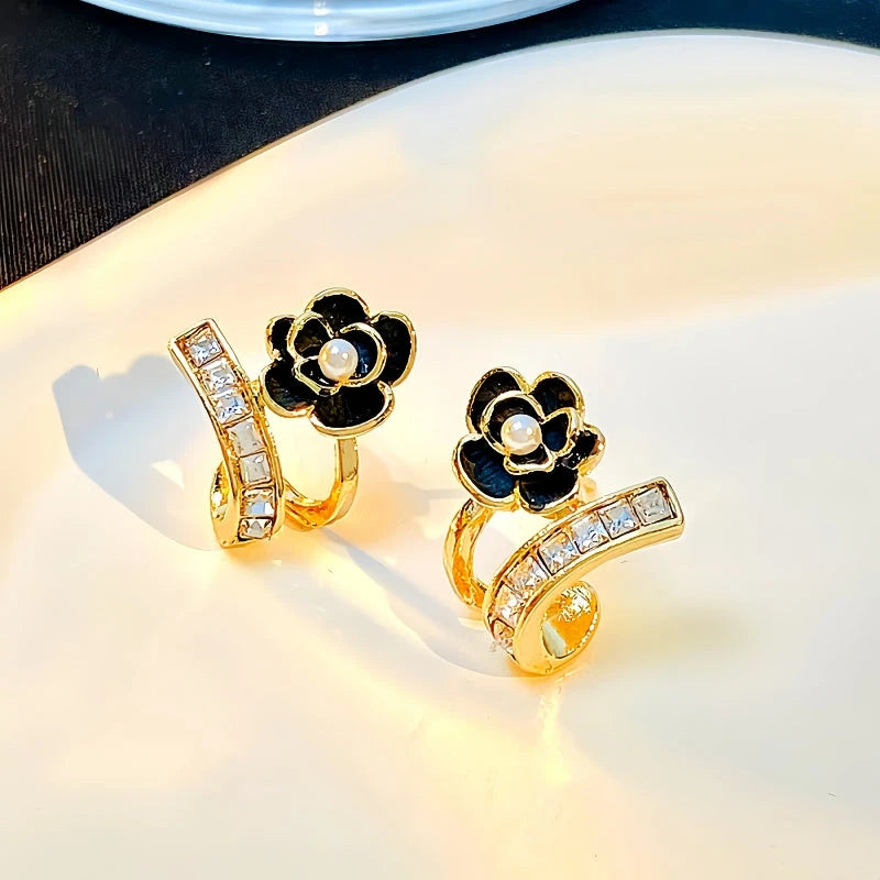 Angled view of the 14K Gold-Plated Exquisite Black Camellia Zircon Stud Earrings