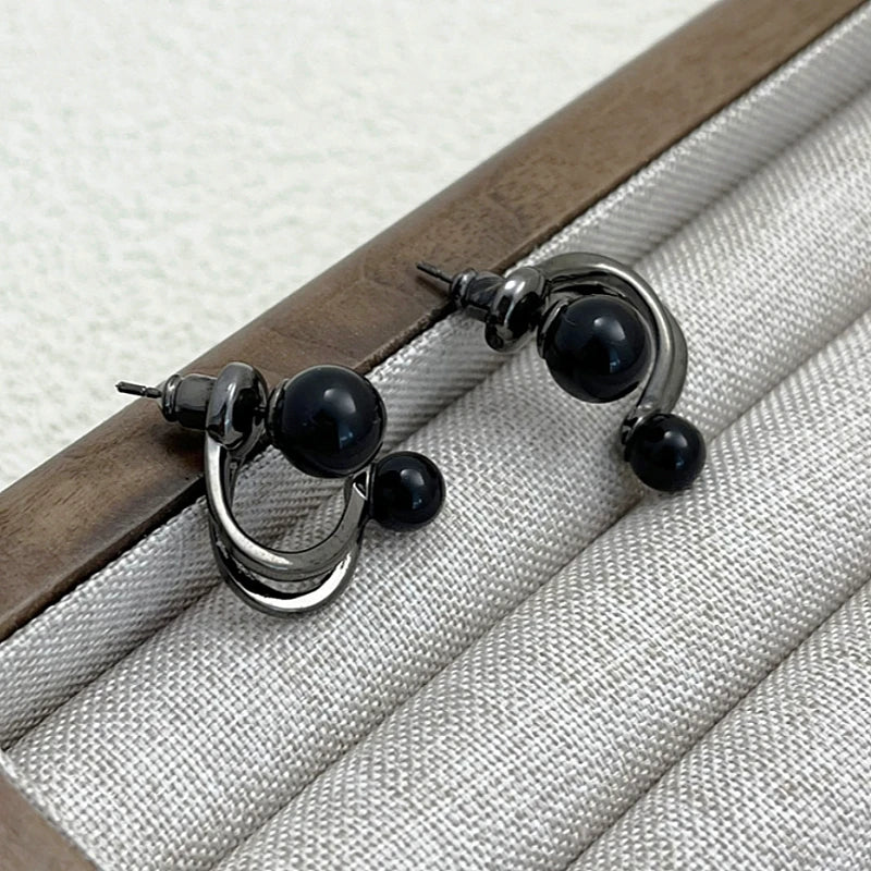 Angled view of the 14K Gold-Plated Exquisite Black Pearl Stud Earrings