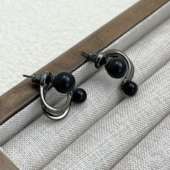 Angled view of the 14K Gold-Plated Exquisite Black Pearl Stud Earrings