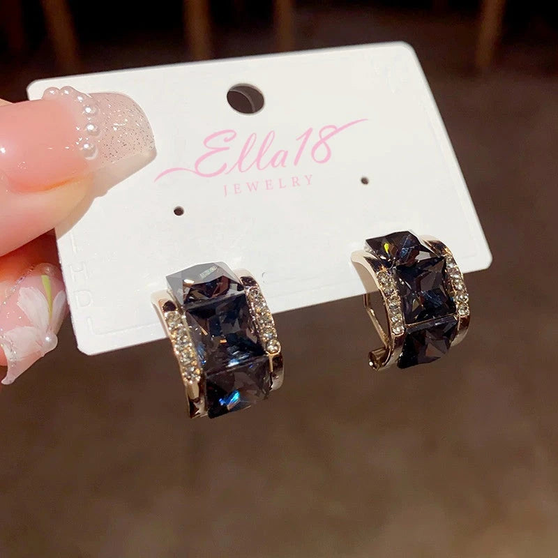 Close-up detail of the sparkling zircons and plating on the Black Square Earrings