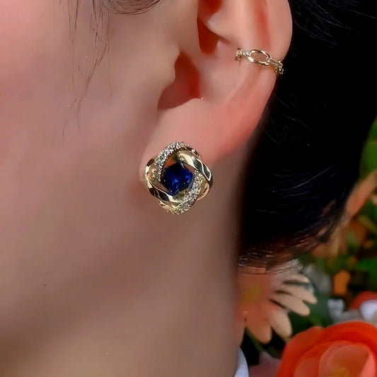 Model showcasing the dangle and style of the 14K Gold-Plated Exquisite Blue Diamond Studs