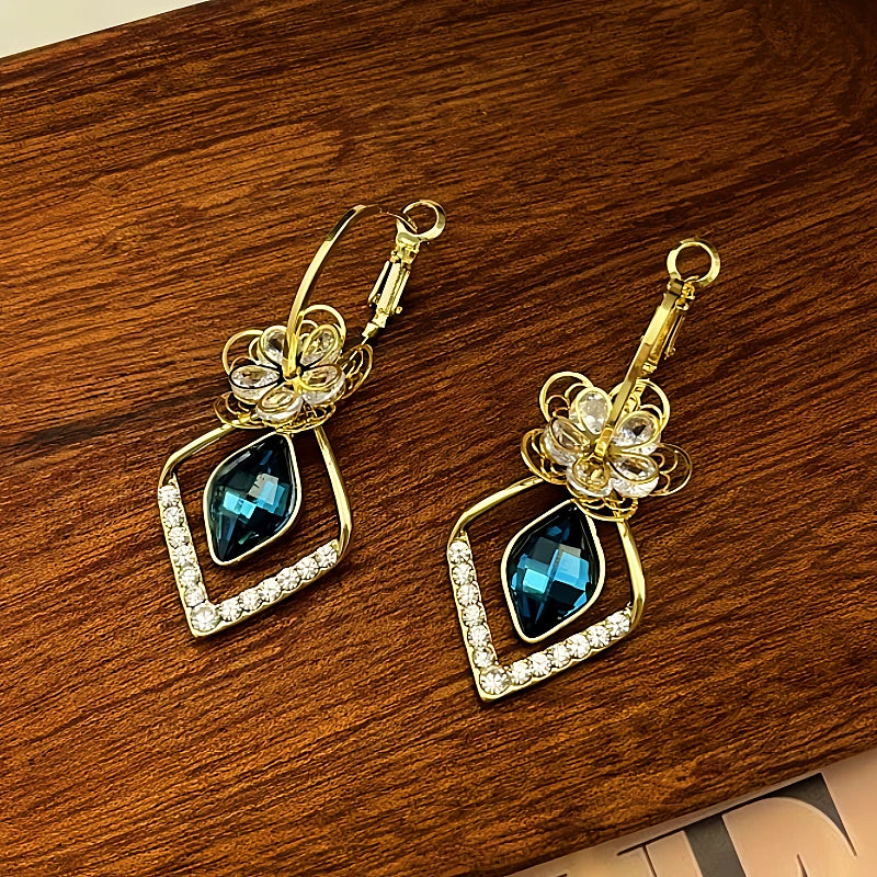 Angled view of the 14K Gold-Plated Exquisite Diamond Flower Crystal Earrings