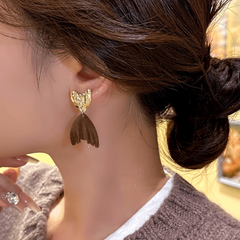 Angled view of the 14K Gold-Plated Exquisite Fishtail Tassel Earrings