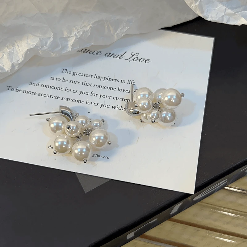 Angled view of the 14K Gold-Plated Exquisite Grape Bead Tassel Earrings