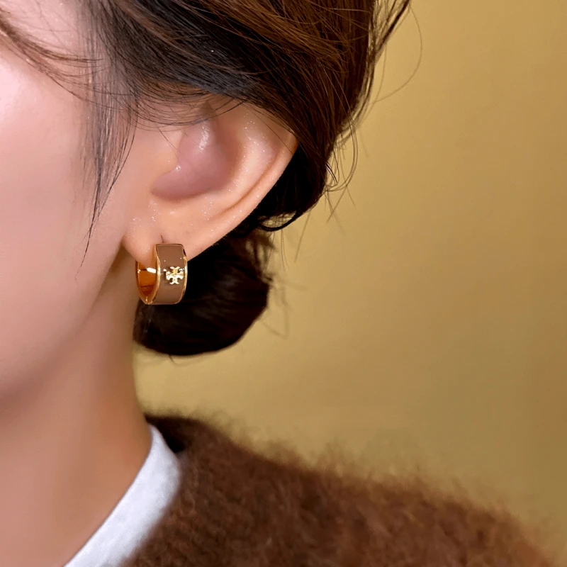 Model showcasing the dangle and style of the 14K Gold-Plated Exquisite Maillard Color Hoop Earrings