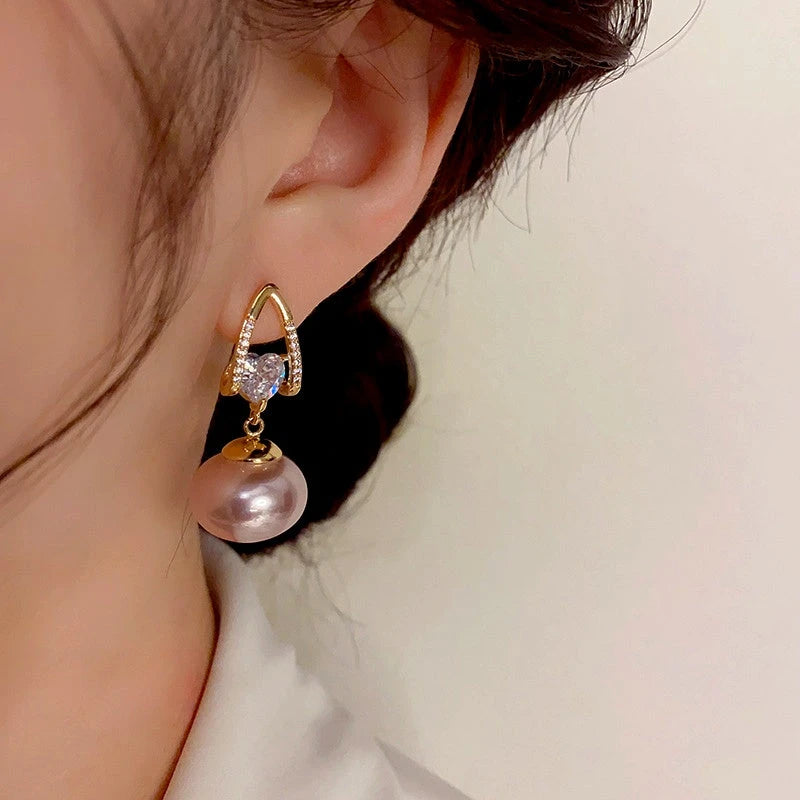 Close-up detail of the sparkling zircons and plating on the Pearl Heart Earrings
