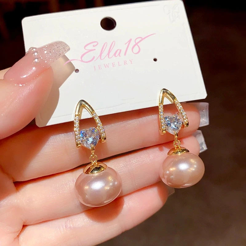 Angled view of the 14K Gold-Plated Exquisite Pearl Zircon Heart Earrings