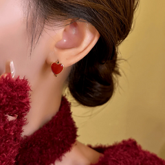 Close-up detail of the sparkling zircons and plating on the Red Heart Hoop Earrings