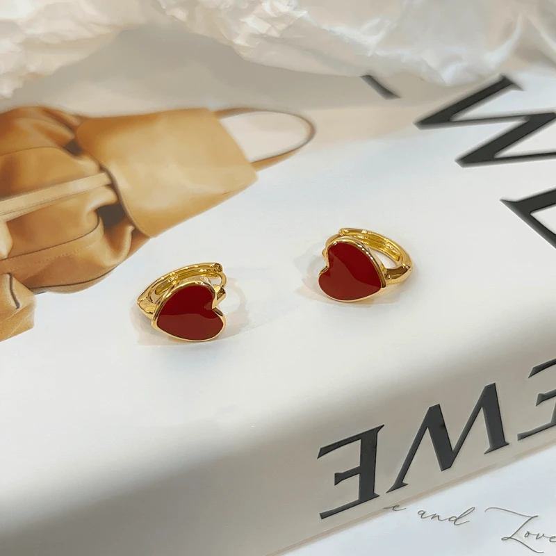 Angled view of the 14K Gold-Plated Exquisite Simple Red Heart Hoop Earrings