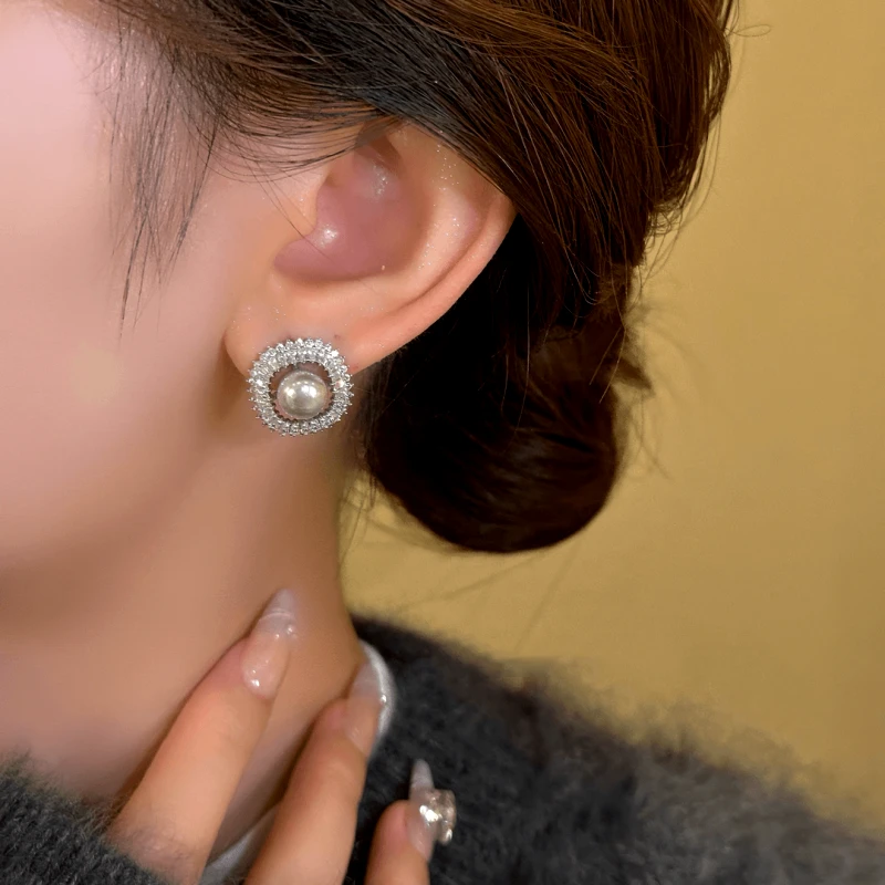 Model showcasing the dangle and style of the 14K Gold-Plated Exquisite Smoky Gray Square Bead Stud Earrings