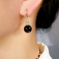 Model showcasing the dangle and style of the 14K Gold-Plated Exquisite Zircon Black Pearl Earrings