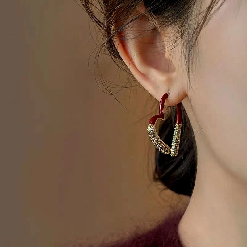 Model showcasing the dangle and style of the 14K Gold-Plated Exquisite Christmas Zircon Heart-Design Earrings