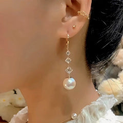 Model showcasing the dangle and style of the 14K Gold-Plated Exquisite Zircon Pearl Tassel Earrings