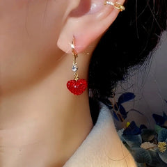 Close-up detail of the sparkling zircons and plating on the Red Heart Earrings