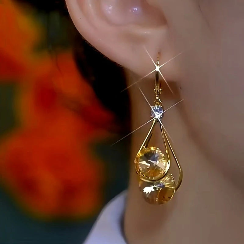 Model showcasing the dangle and style of the 14K Gold-Plated Exquisite Zircon Water Drop Earrings