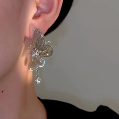 Model showcasing the dangle and style of the 14K Gold-Plated Fairy Butterfly Earrings