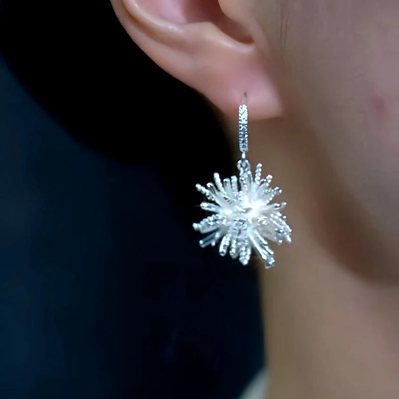 Model showcasing the dangle and style of the 14K Gold-Plated Fireworks Earrings