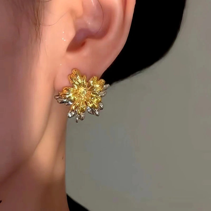 Model showcasing the dangle and style of the 14K Gold-Plated Fireworks Flower Earrings