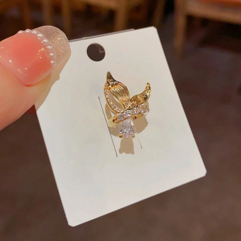 Model showcasing the dangle and style of the 14K Gold-Plated Fishtail Ear Bone Clips ( 1 Pair )