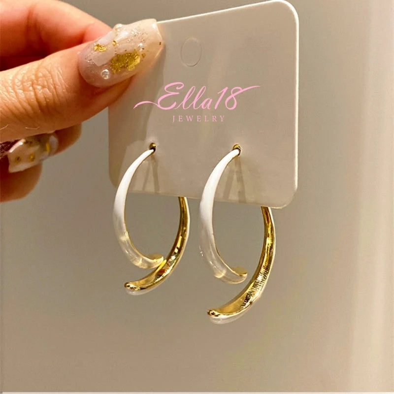 Model showcasing the dangle and style of the 14K Gold-Plated Fishtail Earrings