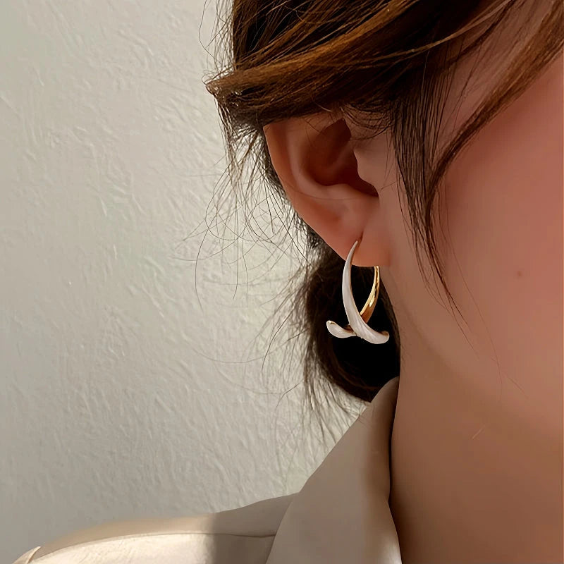 Close-up detail of the sparkling zircons and plating on the Green Fishtail Earrings