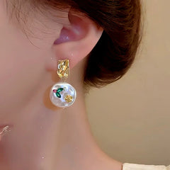 Model showcasing the dangle and style of the 14K Gold-Plated Flower Baroque Pearl Earrings