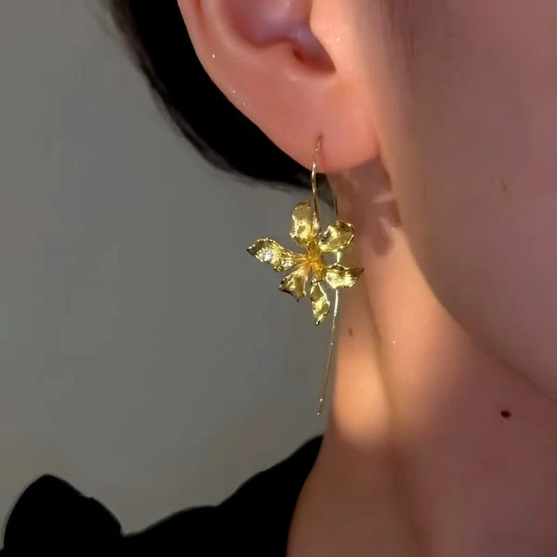 Model showcasing the dangle and style of the 14K Gold-Plated Flower Ear Hook Earrings