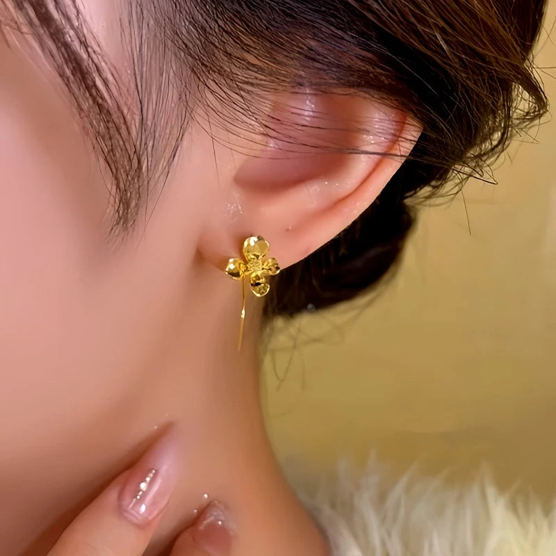 Model showcasing the dangle and style of the 14K Gold-Plated Flower Ear Hook Earrings