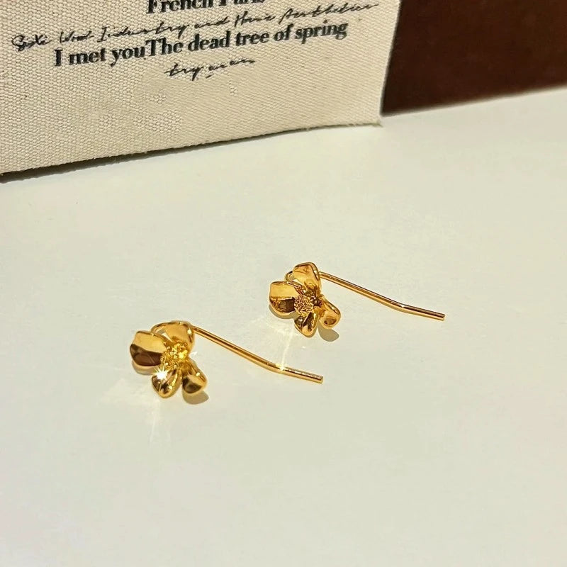 Angled view of the 14K Gold-Plated Flower Ear Hook Earrings