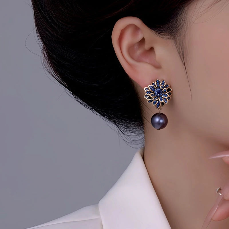 Model showcasing the dangle and style of the 14K Gold-Plated Flower Pearl Earrings