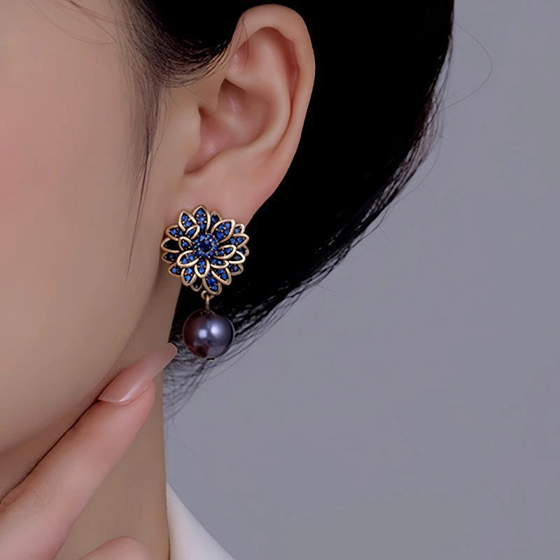 Close-up detail of the sparkling zircons and plating on the Blue Flower Pearl Earrings