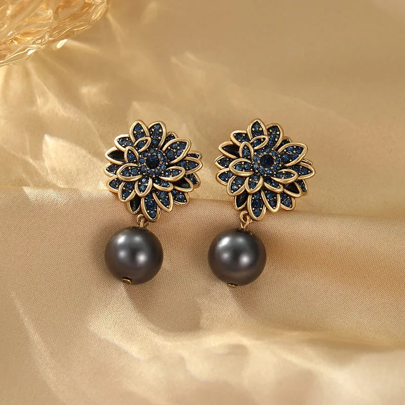 Angled view of the 14K Gold-Plated Flower Pearl Earrings