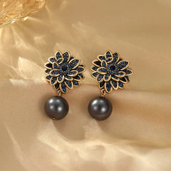 Angled view of the 14K Gold-Plated Flower Pearl Earrings