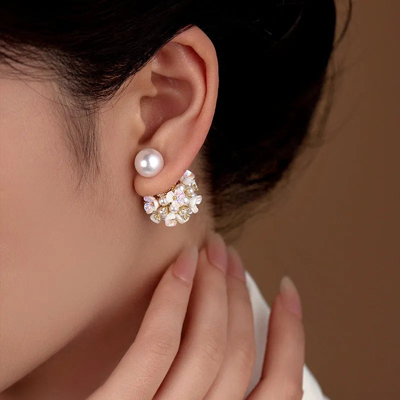 Model showcasing the dangle and style of the 14K Gold-Plated Flower Pearl Jacket Earrings