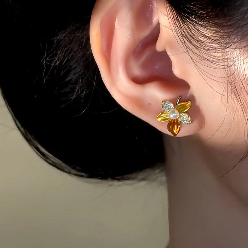 Close-up detail of the sparkling zircons and plating on the Gold Flower Studs