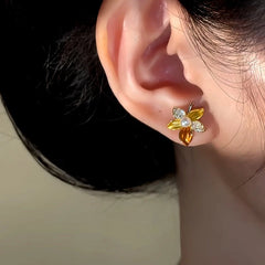 Close-up detail of the sparkling zircons and plating on the Gold Flower Studs