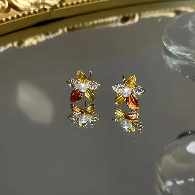 Angled view of the 14K Gold-Plated Flower Stud Earrings