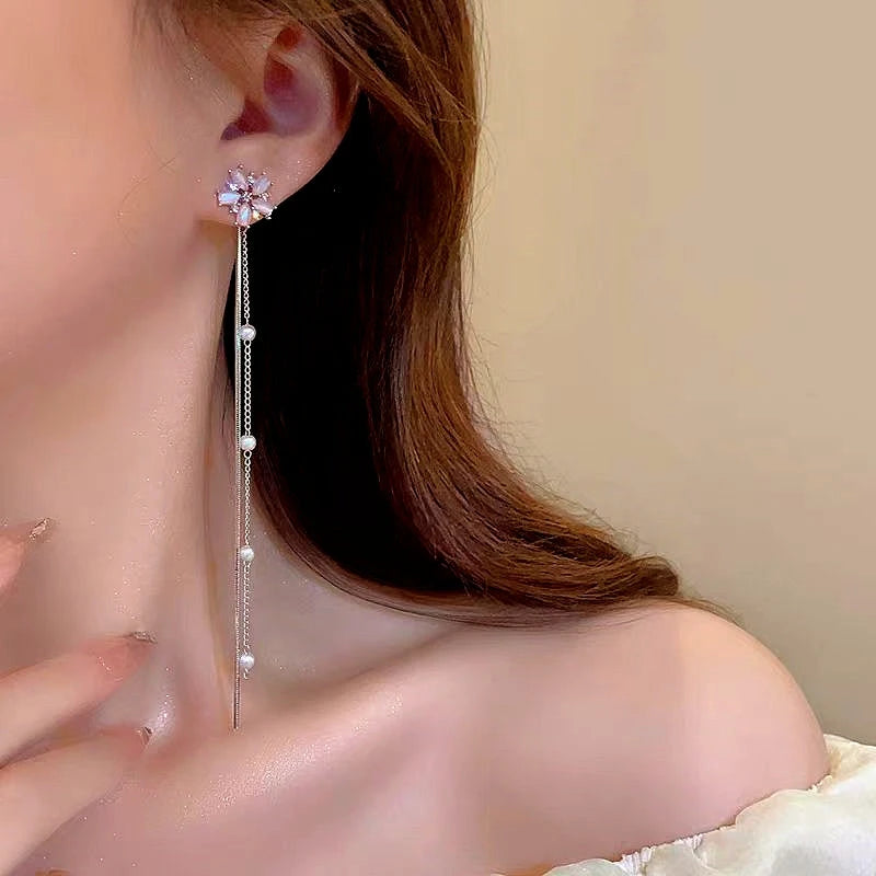 Model showcasing the dangle and style of the 14K Gold-Plated Flower Tassel Earrings