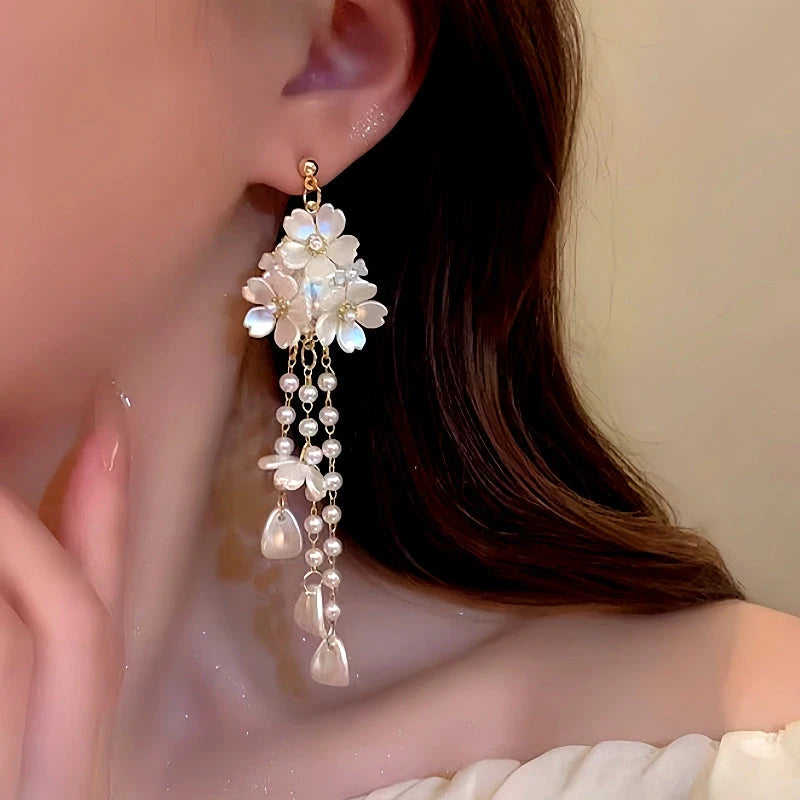 Model showcasing the dangle and style of the 14K Gold-Plated Flower Tassel Earrings
