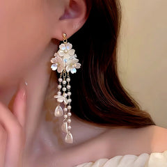 Model showcasing the dangle and style of the 14K Gold-Plated Flower Tassel Earrings