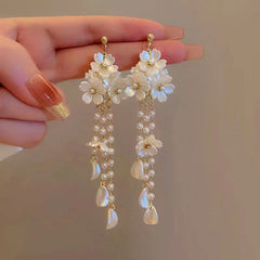 Angled view of the 14K Gold-Plated Flower Tassel Earrings